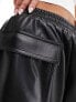 ASOS DESIGN leather look turn up utility shorts in black