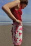 Mini pareo skirt with fretwork and floral print