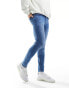 ASOS DESIGN spray on jeans with power stretch in tinted wash blue