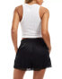 COLLUSION lace hem satin boxer short in black