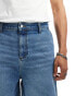 ASOS DESIGN standard length denim jorts with carpenter detailing in mid wash blue