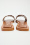 Flat leather slider sandals with metal appliqués