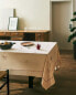 Tablecloth with embroidered objects