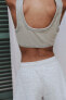 Faded-effect ribbed crop top with rips