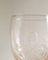 Raised design glass tumbler