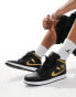 Air Jordan 1 mid trainers in black and gold