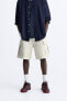 Ripped cargo bermuda shorts