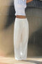 Flowing trousers with pleats