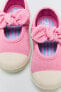 Open sneakers with bow