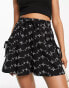 ASOS DESIGN broderie shorts with tie pockets in black/white