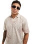 ASOS DESIGN relaxed polo shirt in beige with multi sun prints