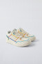 Minimalist lace-up sneakers with multicoloured trim