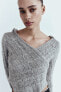 Asymmetric knit sweater with hood