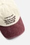 CAP WITH EMBROIDERED SLOGAN