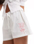 Фото #1 товара ASOS DESIGN poplin pull on shorts with floral embroidery in white