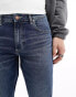 ASOS DESIGN stretch tapered jeans in mid wash blue