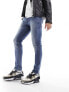 ASOS DESIGN skinny jeans with abrasions in mid wash blue