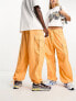 Weekday Unisex parachute baggy trousers in orange exclusive to ASOS