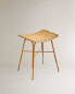 Metal stool with woven rattan