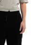 Фото #7 товара ASOS DESIGN oversized ribbed velour shorts in black with cargo pockets