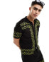 ASOS DESIGN co-ord knitted revere polo in black with green border