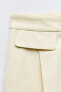 High-waist trousers with flaps
