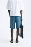 Pleated bermuda shorts with belt