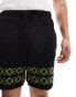 ASOS DESIGN co-ord knitted shorts in black with green border