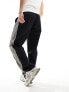 Фото #5 товара ASOS DESIGN baggy nylon track pants in black with grey side stripe