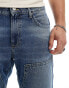 ASOS DESIGN tapered jeans in mid blue wash with carpenter details Голубой, W31 L32 - фото #3