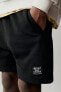 Plush bermuda shorts with label detail
