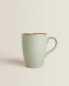 Porcelain mug with antique finish rim