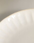 Stoneware dinner plate with raised design