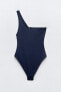 Asymmetric swimsuit with metal piece