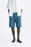 Pleated bermuda shorts with belt