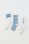 Pack of three pairs of long striped and slogan socks