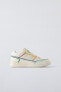 Minimalist lace-up sneakers with multicoloured trim