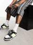 Nike Dunk Low retro trainers in black and yellow