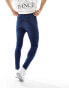 ASOS DESIGN spray on jeans with power-stretch in mid wash blue