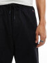 Tommy Jeans parachute trousers in black