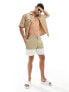 ASOS DESIGN swim shorts in mid length in khaki block print