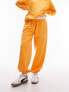 Topshop – Oversize-Jogginghose in oranger Vintage-Waschung mit „NYC Project“-Schaumprint, Kombiteil