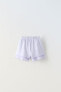 Plush bermuda shorts with bow and ruffles