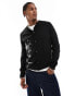 ASOS DESIGN knitted crew neck cardigan with embroidered daisy pattern in black