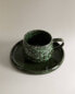 Green stoneware coffee cup and saucer