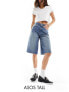 ASOS DESIGN Tall baggy longline denim jorts in midwash blue