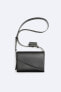 Crossbody bag with asymmetric flap