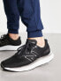 New Balance EVOZ trainers in black and white