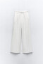 Flowing trousers with pleats