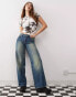 Weekday Ample low waist baggy fit jeans in faded streaky washed blue